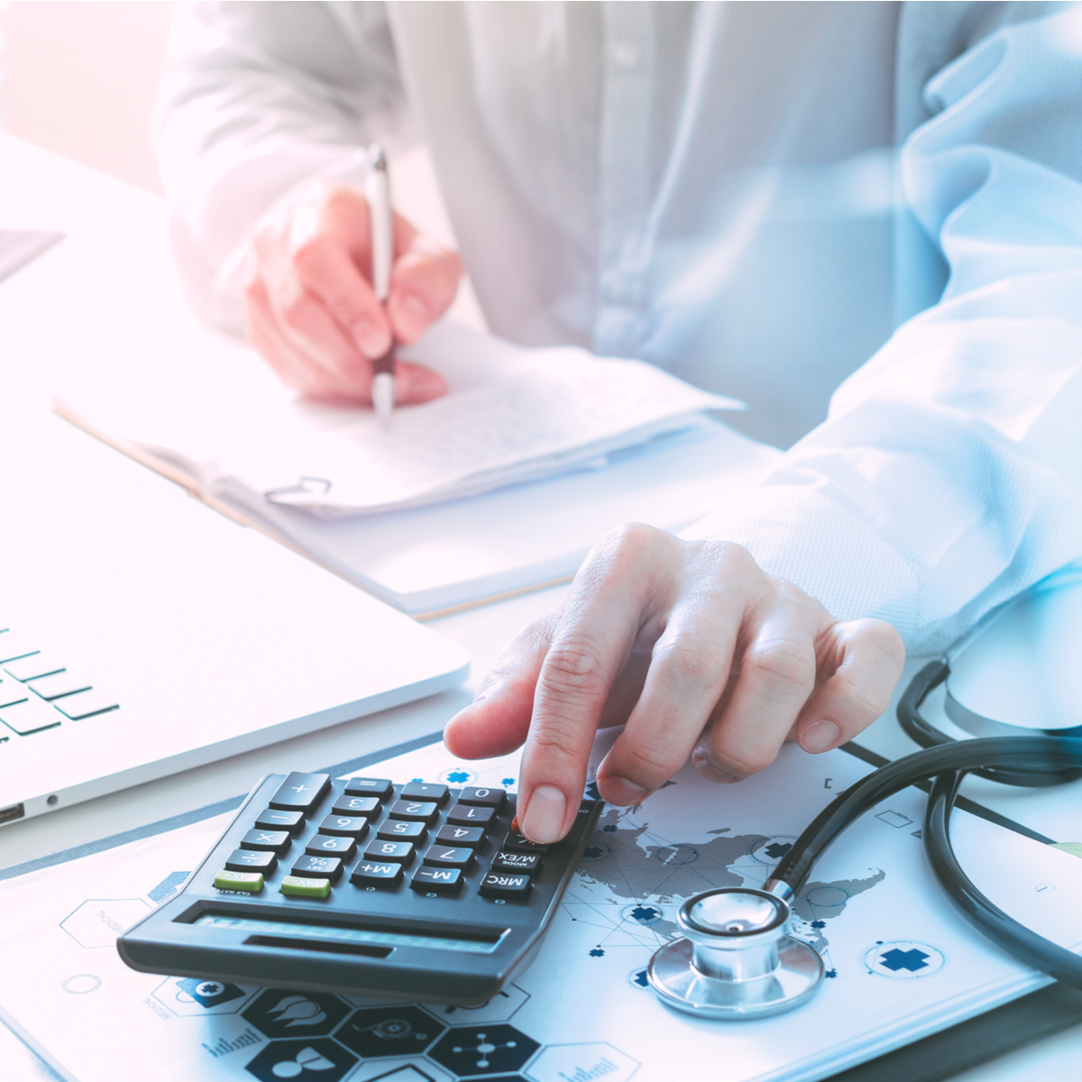 doctor at desk using calculator